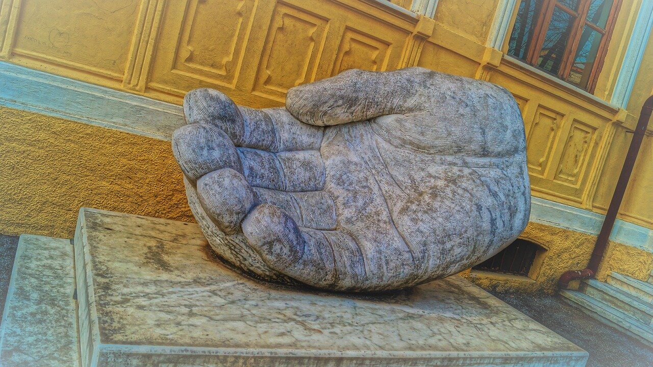 Peter Kay smiles warmly on stage, engaging with an enthusiastic audience during his standup performance