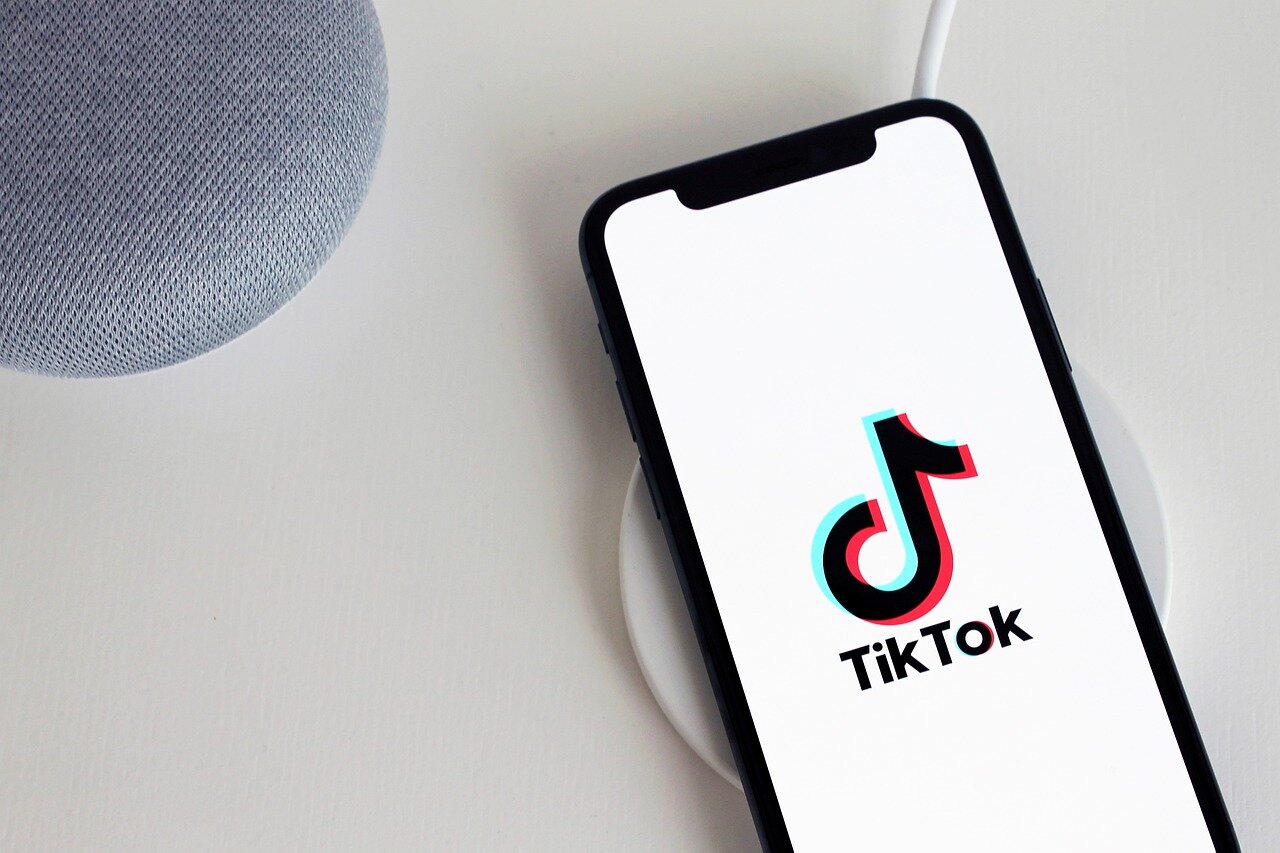 A scene depicting enthusiastic young consumers interacting with TikTok shopping content, reflecting the platform's influence on their purchasing decisions
