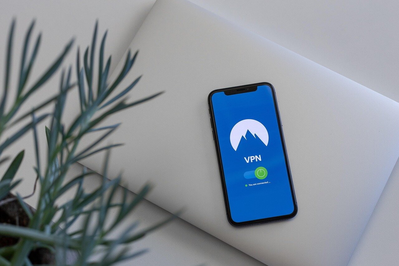 A closeup of a mobile device displaying a VPN app, emphasizing the importance of online privacy in public spaces