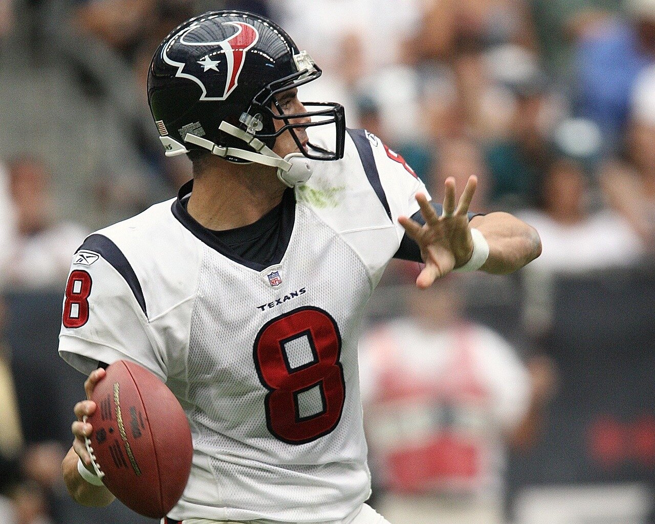 Tua Tagovailoa in action, delivering a precise throw that results in one of his three touchdown passes against the Patriots in a highscoring game