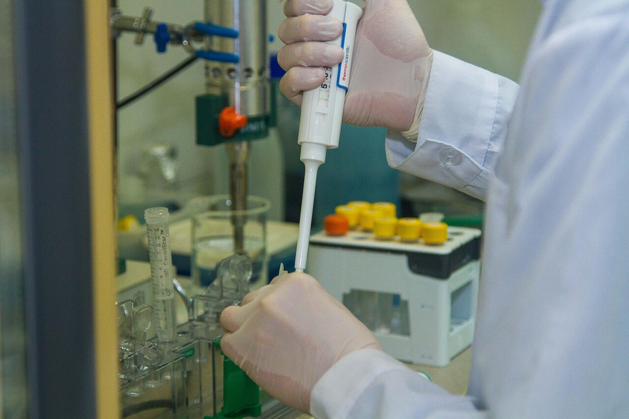 A researcher examines a sample under a microscope, highlighting the presence of microplastics in human tissues during a scientific study.
