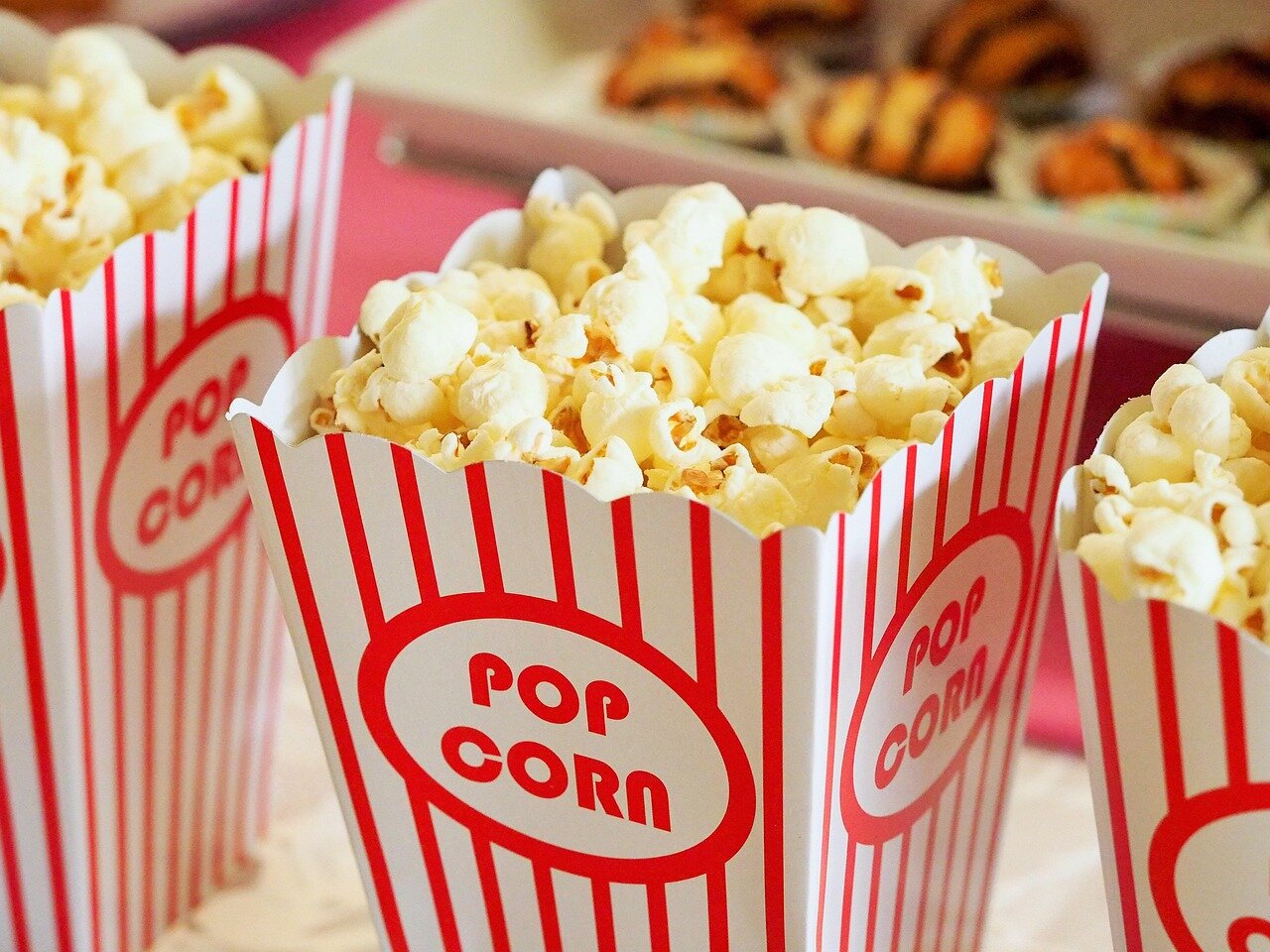 A crowd gathers outside a theater, eagerly discussing the newly released film that portrays a character with a hearing condition as having a superpower.