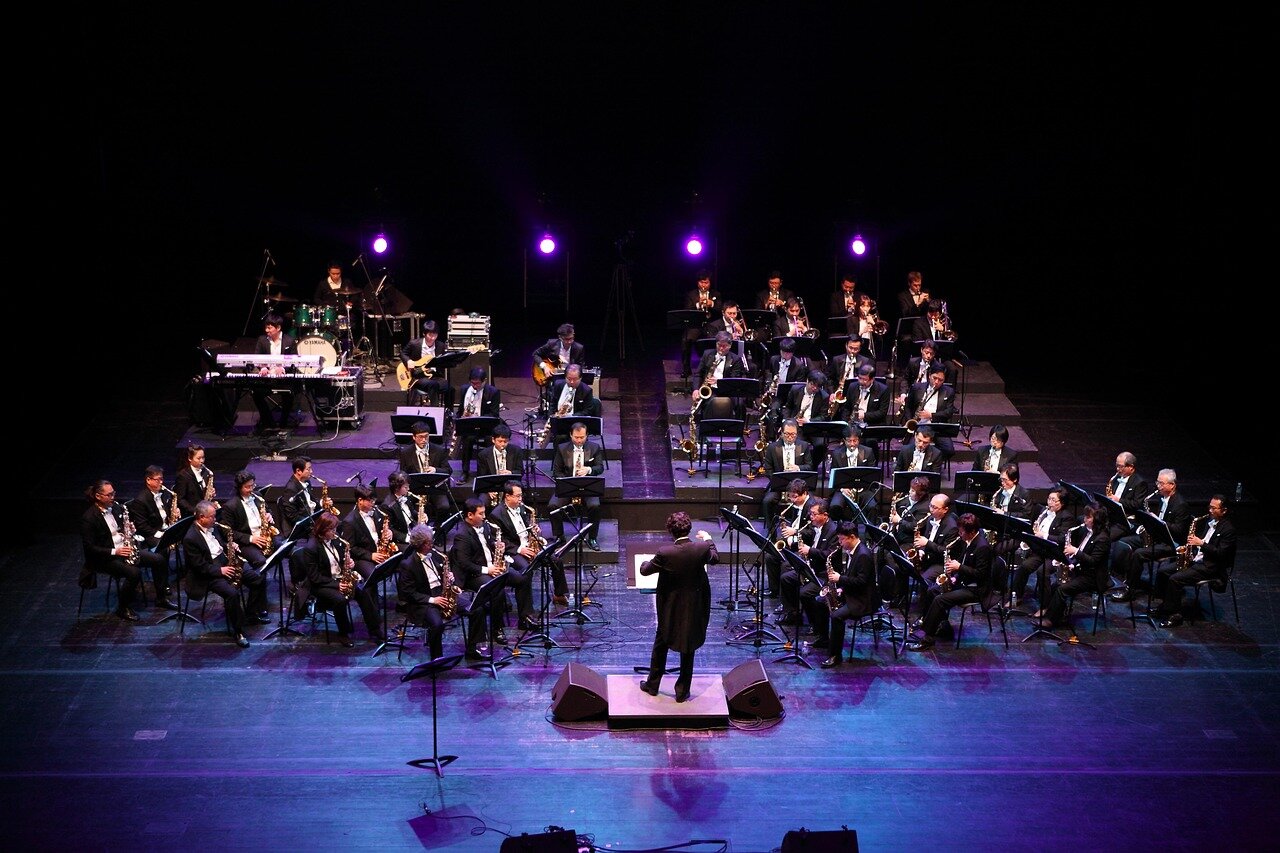 The conductor in a thoughtful moment, reflecting on the intersection of his dual passions for music and aviation, inspiring unique outreach initiatives