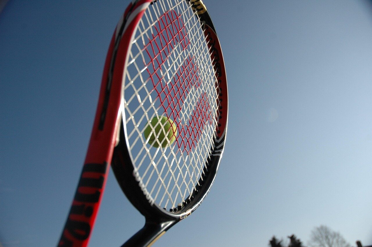 A closeup of Tiafoe's racquet, symbolizing the essential role it plays in his identity and performance as a professional athlete