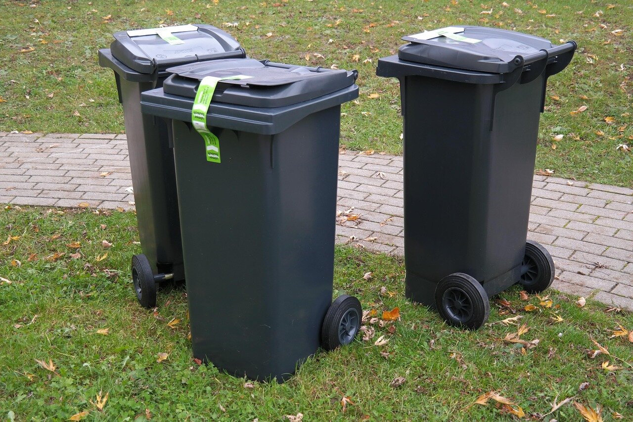 A government official reviewing new waste carrier licensing documents, emphasizing the importance of accountability in waste management