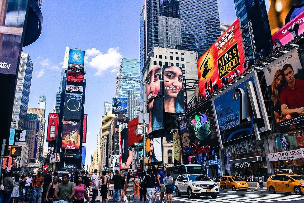 A bustling theater district comes alive with eager fans waiting in line to purchase tickets for the first show after the threeweek closure