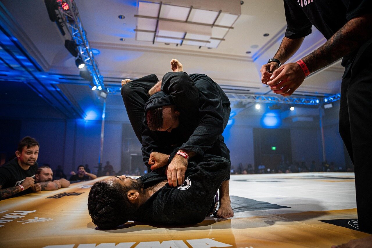 A group of gamers intensely focused on their screens as they compete in UFC 6, showcasing the game's vibrant graphics and dynamic fighting action.