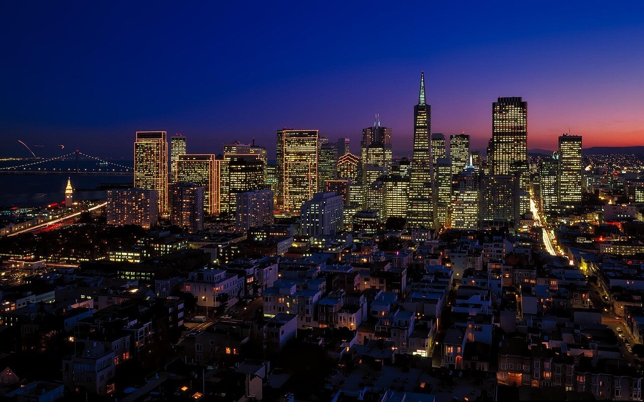 A group of luxury real estate developers discusses plans for new highend housing projects in a bustling San Francisco neighborhood, showcasing modern architectural designs and ecofriendly materials.