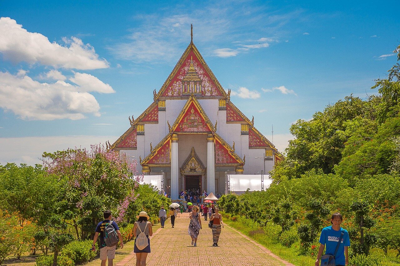 Floral tributes laid at significant landmarks, representing the collective mourning of the Thai people