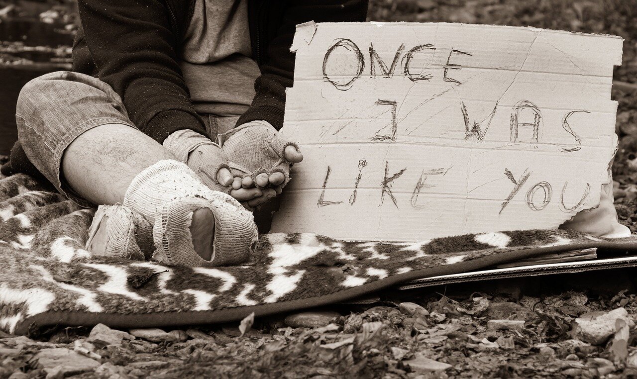 A group of young adults sits together in a park, discussing their concerns about job stability and the future of employment in a changing economy.