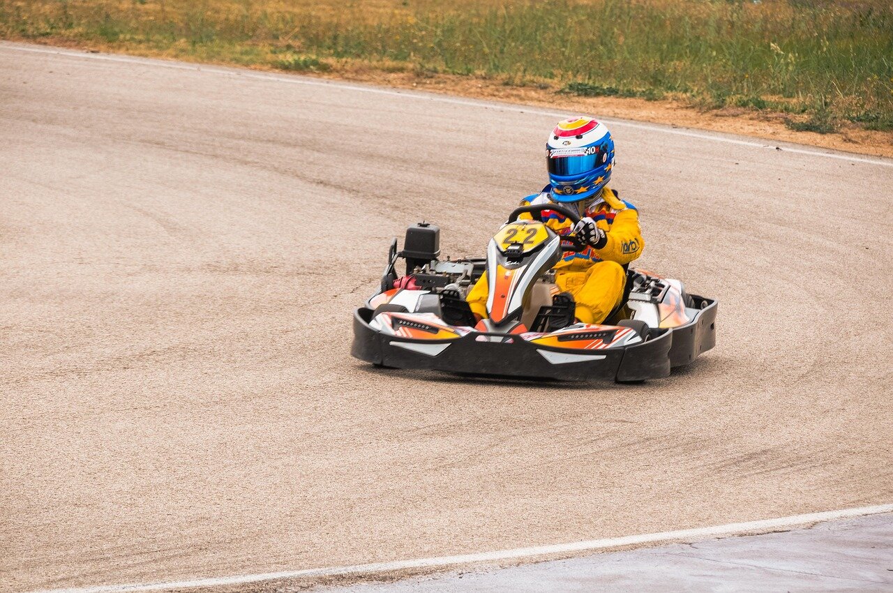 Players enthusiastically race on a newly introduced track in Mario Kart 8 Deluxe, showcasing vibrant graphics and familiar characters amidst a lively gaming atmosphere.