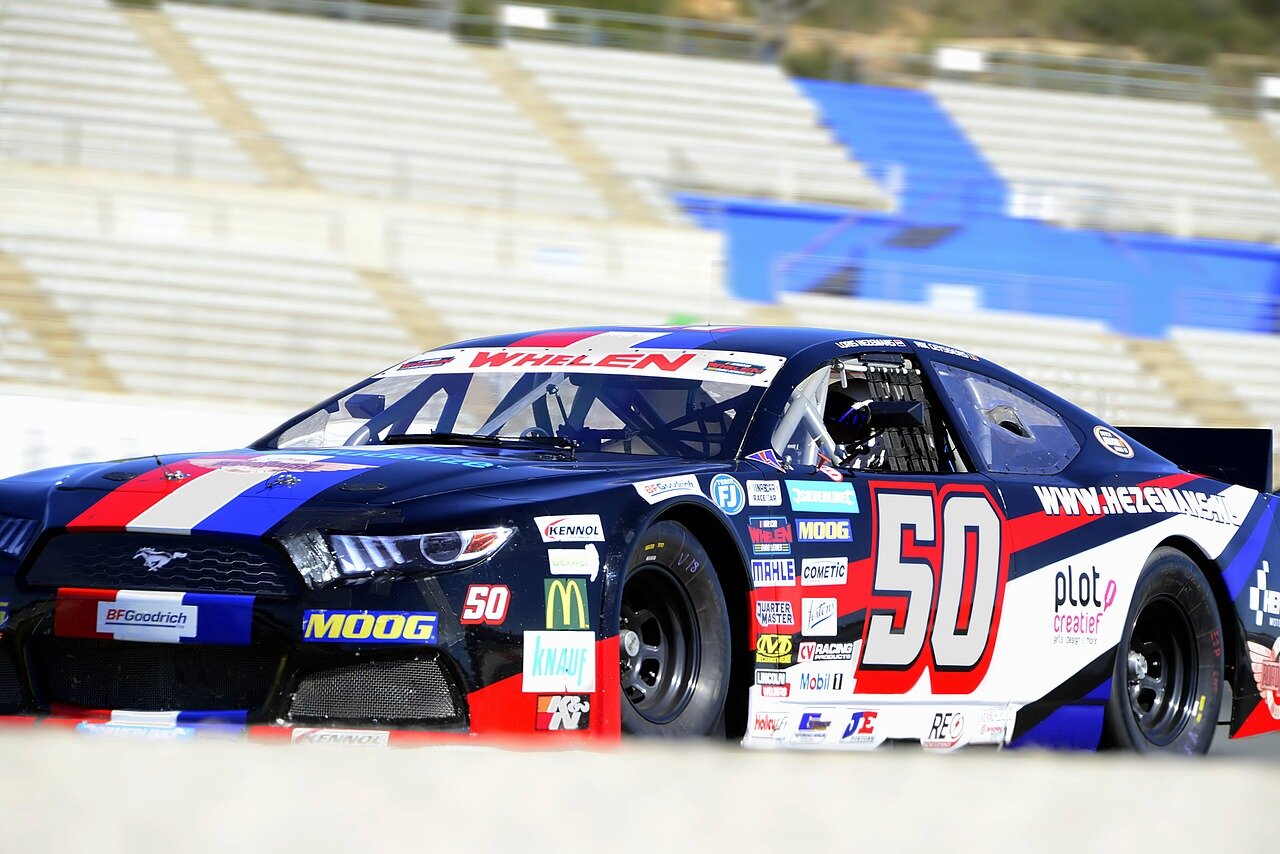 Fans cheering enthusiastically in the grandstands, highlighting the electric atmosphere of the 2026 NASCAR Cup event