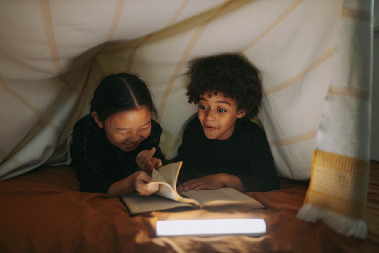 An educator demonstrating the Yoto Music Box in a classroom, capturing the attention of curious students eager to learn through interactive storytelling